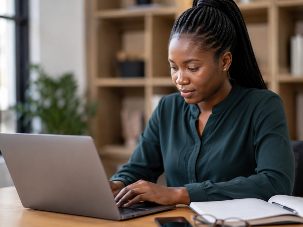 Young South African job seeker applying for a government learnership opportunity online in a professional office environment.