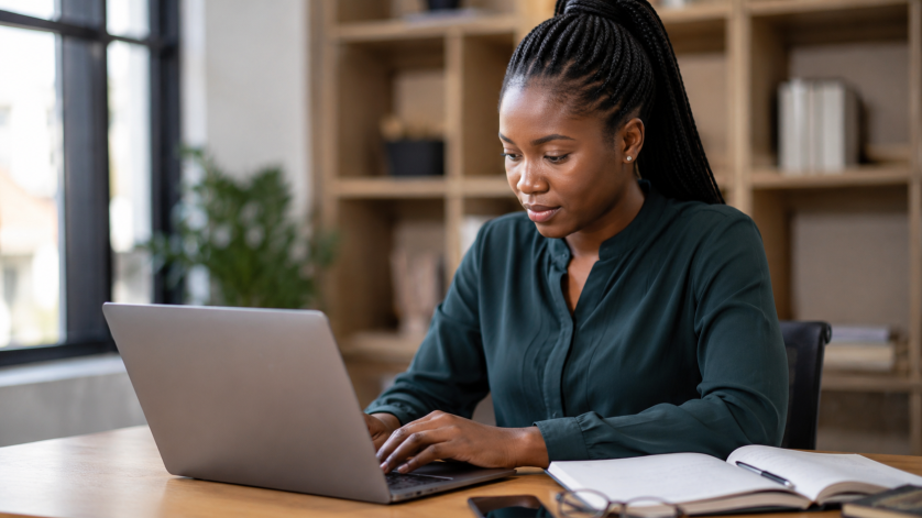 Young South African job seeker applying for a government learnership opportunity online in a professional office environment.