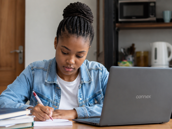 South African student using a Connex laptop while completing an online NSFAS application at home