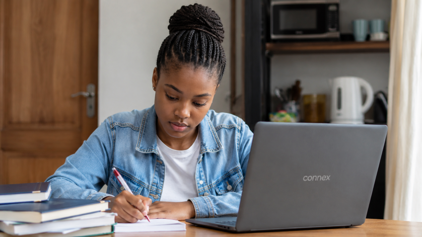 South African student using a Connex laptop while completing an online NSFAS application at home