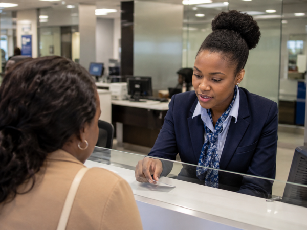 Young South African banking learnership candidates receiving training inside a modern bank branch